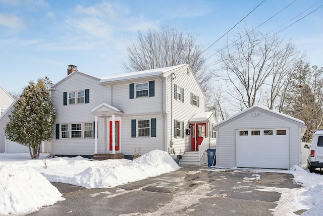 view of front of property with a garage and an outdoor structure