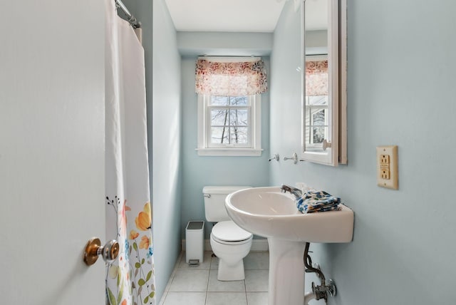 bathroom featuring tile patterned flooring and toilet