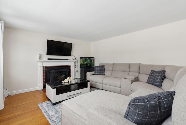 living room with wood-type flooring and a fireplace