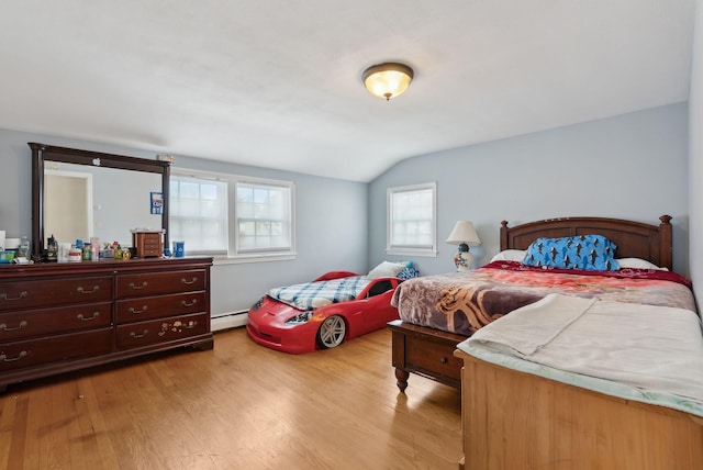 bedroom featuring light wood-type flooring, a baseboard radiator, and lofted ceiling