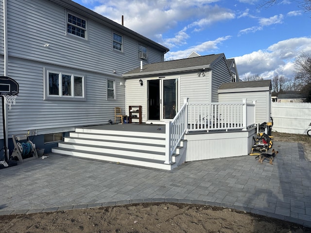 back of house with a wooden deck and a patio area