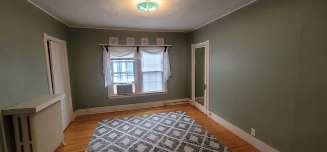 28 Maine Ave, Millinocket, ME 04462 - unfurnished room with cooling unit, light wood-style flooring, a textured ceiling, and crown molding