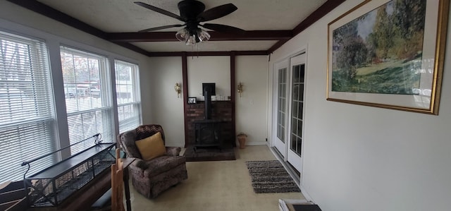 28 Maine Ave, Millinocket, ME 04462 - living area featuring a wood stove, beamed ceiling, ceiling fan, carpet floors, and french doors