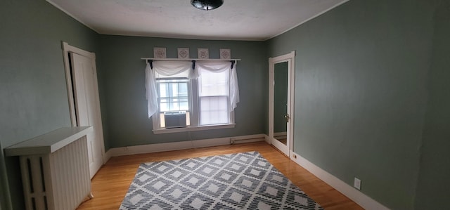 28 Maine Ave, Millinocket, ME 04462 - spare room with cooling unit, radiator, and light wood-style flooring