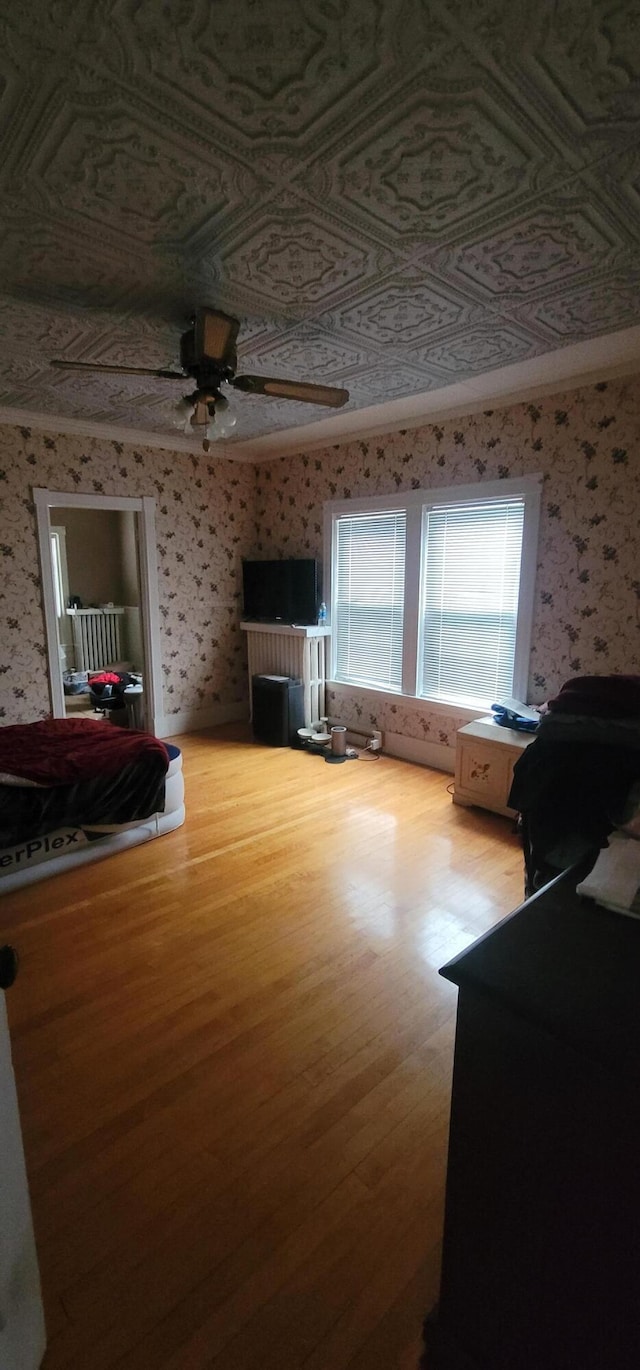 28 Maine Ave, Millinocket, ME 04462 - living area with a ceiling fan, wallpapered walls, and wood finished floors