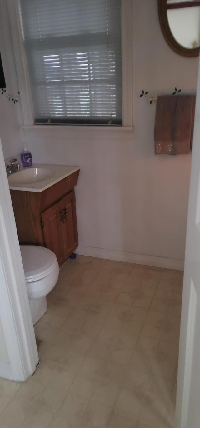 28 Maine Ave, Millinocket, ME 04462 - half bath featuring vanity and tile patterned floors