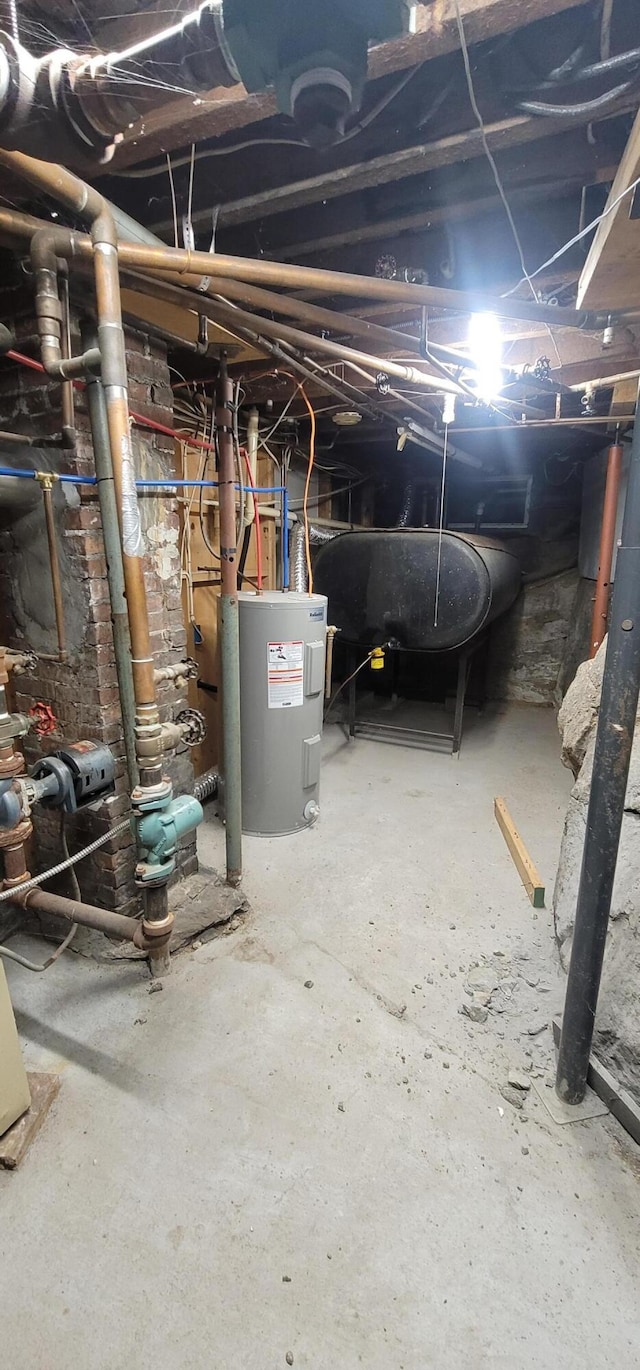 28 Maine Ave, Millinocket, ME 04462 - unfinished below grade area featuring electric water heater and oil tank
