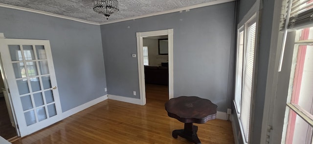 28 Maine Ave, Millinocket, ME 04462 - empty room with wood finished floors, healthy amount of natural light, an ornate ceiling, and ornamental molding