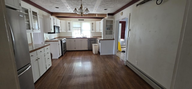 28 Maine Ave, Millinocket, ME 04462 - kitchen with appliances with stainless steel finishes, a chandelier, baseboard heating, dark wood finished floors, and white cabinets