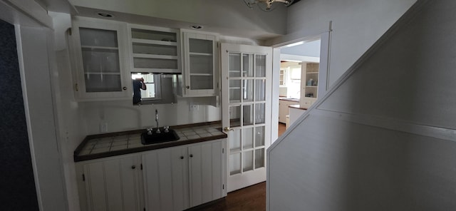 28 Maine Ave, Millinocket, ME 04462 - kitchen with tile countertops, dark wood-style floors, white cabinets, and glass insert cabinets