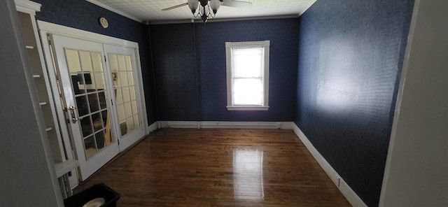28 Maine Ave, Millinocket, ME 04462 - unfurnished room with wood finished floors, ceiling fan, ornamental molding, and french doors