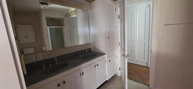28 Maine Ave, Millinocket, ME 04462 - bathroom with a shower stall, double vanity, and tile patterned floors