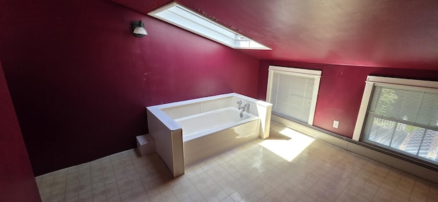 28 Maine Ave, Millinocket, ME 04462 - full bathroom featuring tile patterned floors, a skylight, and a bath