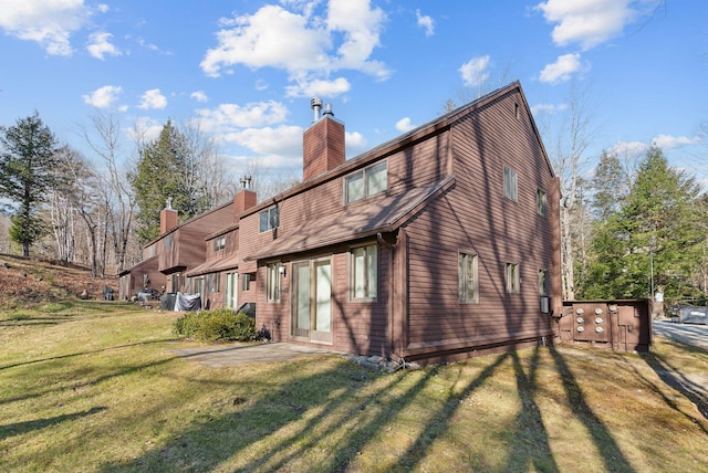 rear view of house with a yard