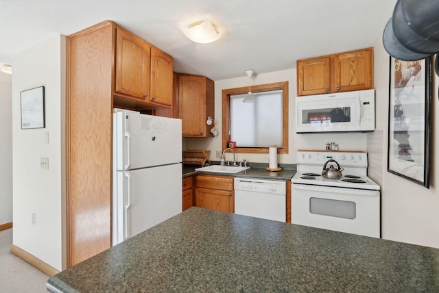 kitchen featuring white appliances and sink