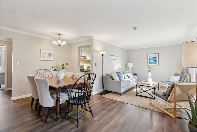 dining area with crown molding, dark hardwood / wood-style flooring, and an inviting chandelier