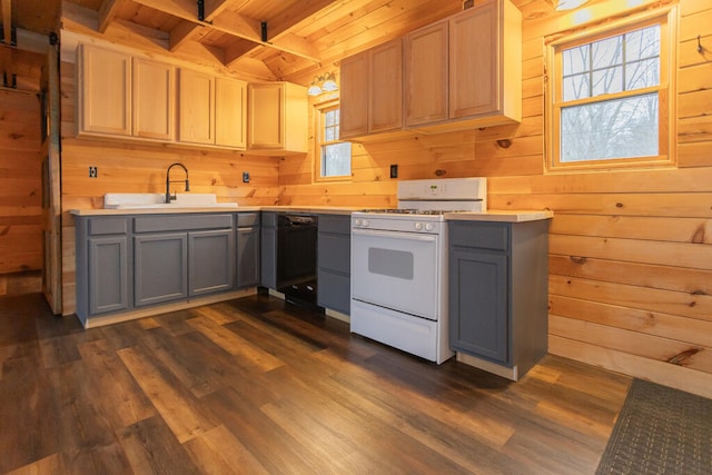 kitchen featuring sink, dark wood-type flooring, wooden ceiling, white range with gas stovetop, and wooden walls