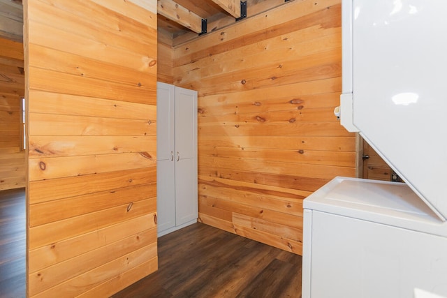 laundry area featuring wood walls and dark hardwood / wood-style flooring