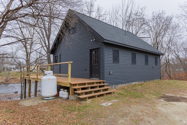 view of side of property with a wooden deck