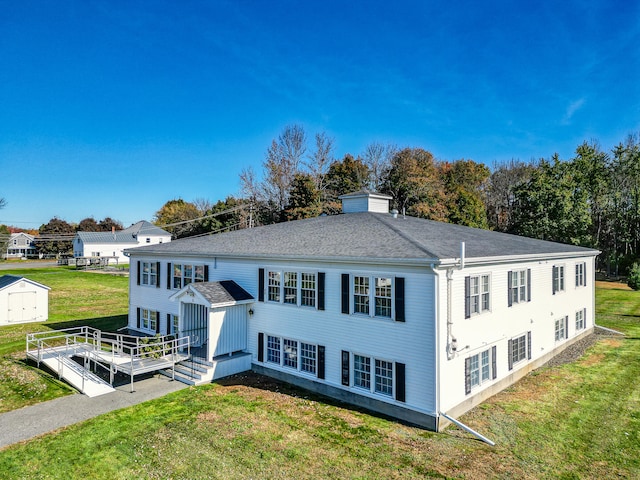 back of house with a yard and a deck