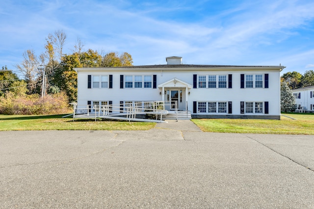 raised ranch with a front lawn