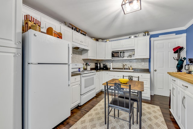 kitchen featuring white cabinets, dark hardwood / wood-style floors, white appliances, and ornamental molding