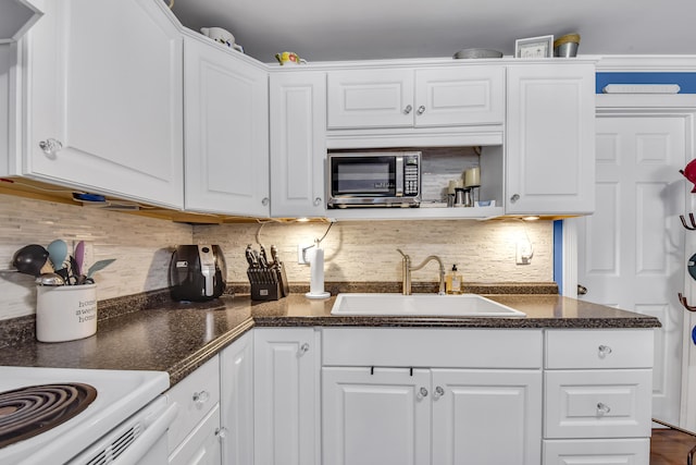 kitchen with white cabinets, tasteful backsplash, and sink