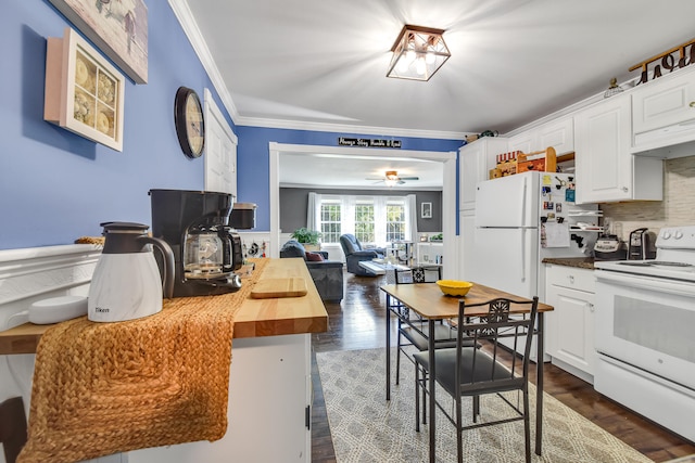 kitchen with white appliances, crown molding, white cabinetry, dark hardwood / wood-style flooring, and butcher block counters