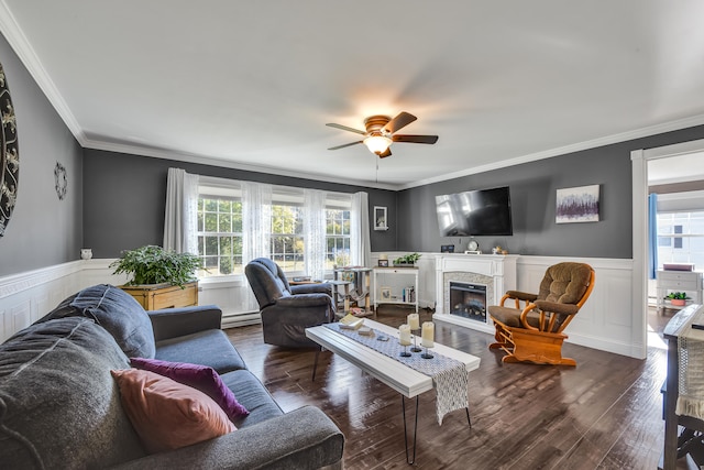 living room featuring ornamental molding, plenty of natural light, and dark wood-type flooring