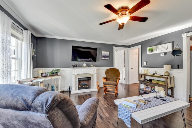 living room featuring crown molding, dark hardwood / wood-style flooring, and ceiling fan