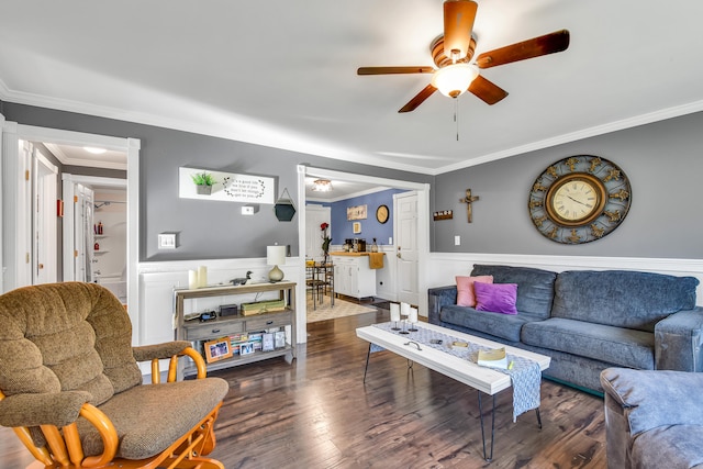 living room featuring dark hardwood / wood-style floors, ceiling fan, and crown molding