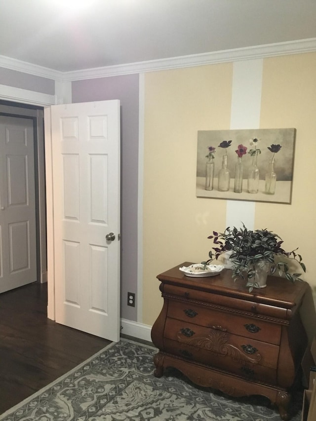 interior space featuring dark hardwood / wood-style flooring and ornamental molding