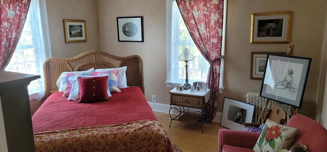 bedroom featuring light wood-type flooring and multiple windows