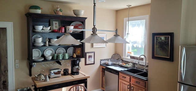 kitchen featuring appliances with stainless steel finishes, pendant lighting, and sink