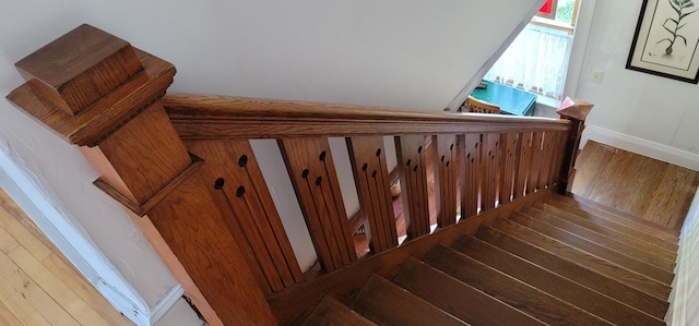 stairs featuring hardwood / wood-style flooring