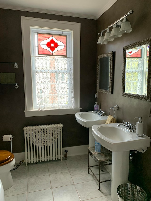 bathroom featuring tile patterned flooring, radiator heating unit, toilet, and crown molding