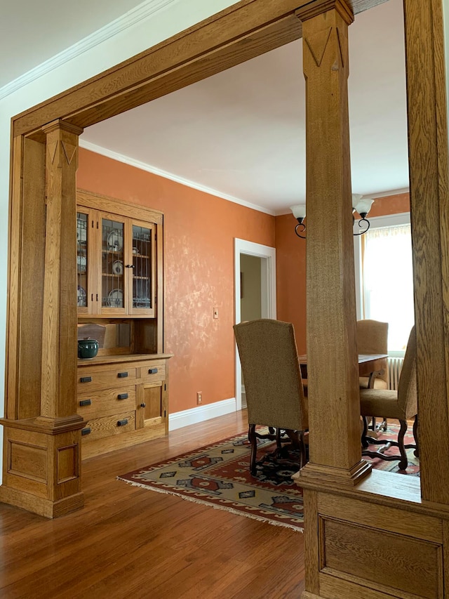 home office with ornate columns, wood-type flooring, and ornamental molding