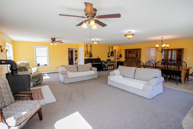 carpeted living room with ceiling fan with notable chandelier and a baseboard radiator