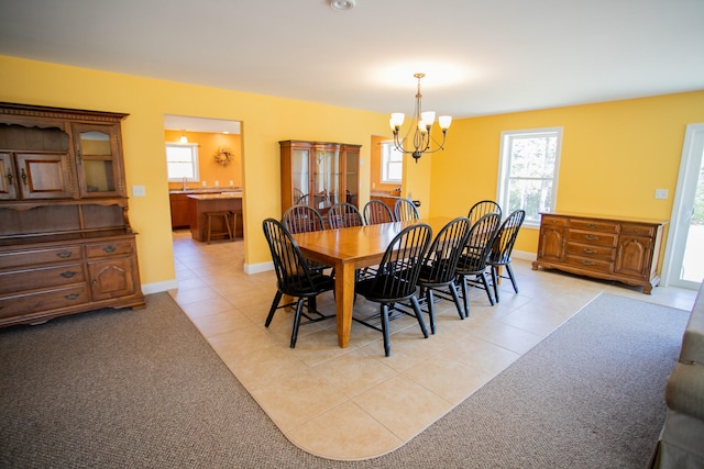 dining space featuring an inviting chandelier and light tile patterned flooring