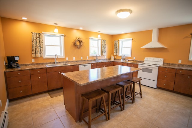 kitchen with sink, a center island, a kitchen breakfast bar, extractor fan, and white appliances