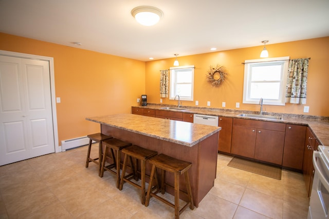 kitchen with baseboard heating, a breakfast bar, sink, and white appliances