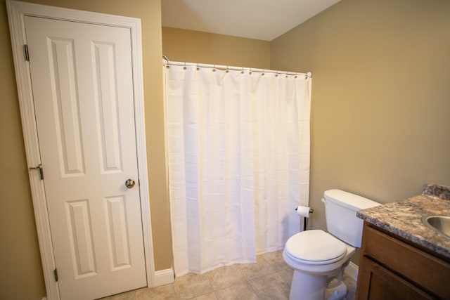 bathroom featuring tile patterned floors, vanity, and toilet