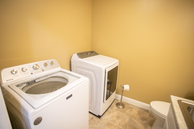 washroom featuring light tile patterned floors, separate washer and dryer, and sink