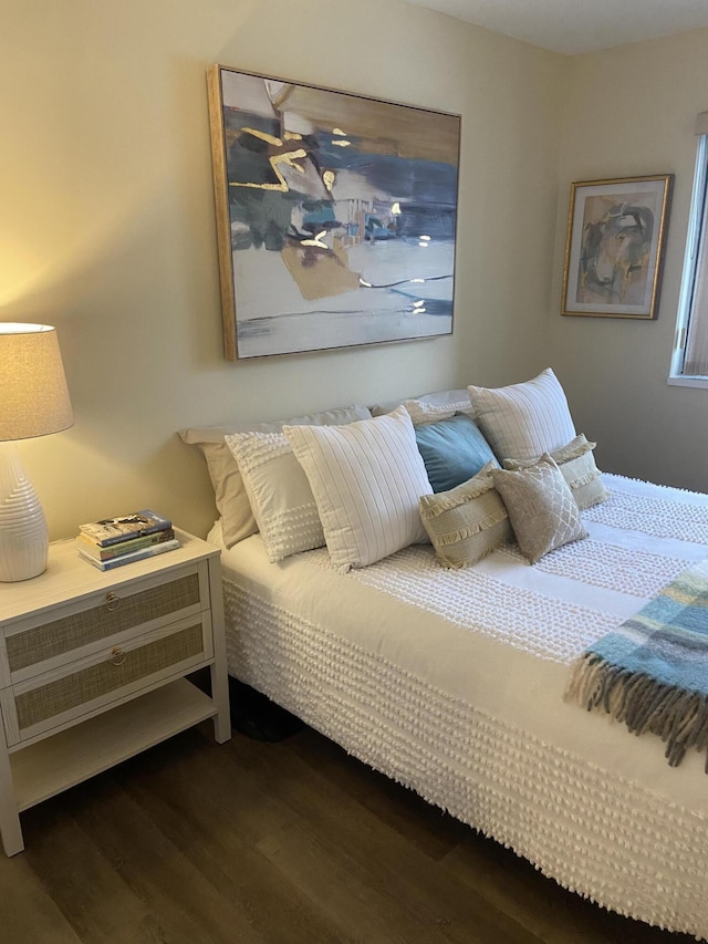 bedroom with dark hardwood / wood-style floors