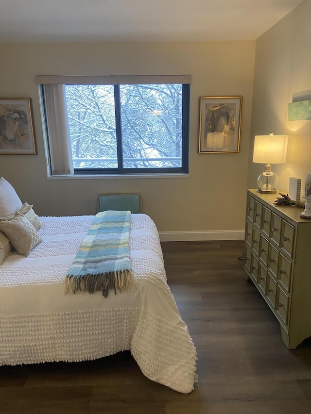 bedroom with dark wood-type flooring