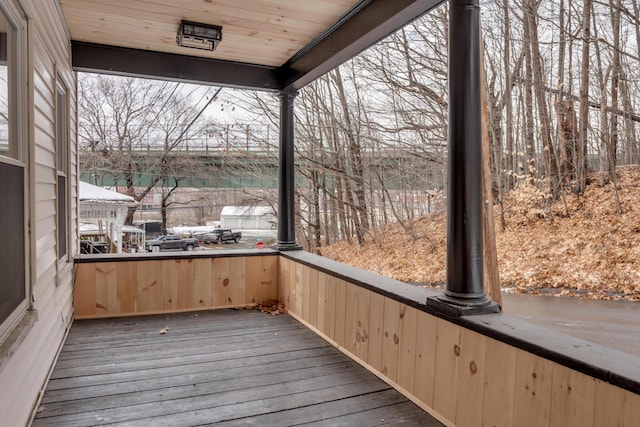 unfurnished sunroom featuring wooden ceiling and a healthy amount of sunlight