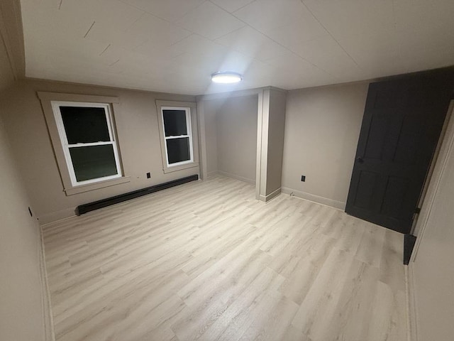 basement with light hardwood / wood-style floors