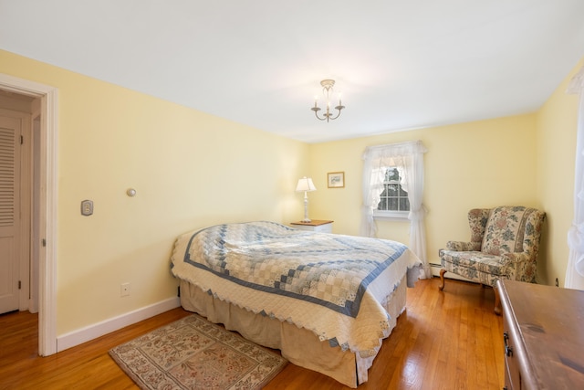 bedroom featuring a chandelier and wood-type flooring