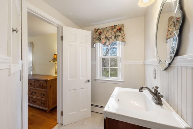 bathroom featuring vanity, tile patterned floors, and baseboard heating