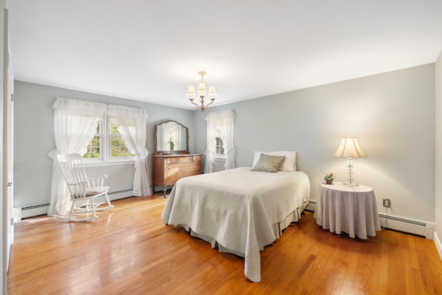 bedroom with wood-type flooring, a baseboard radiator, and a notable chandelier